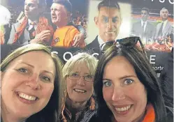  ??  ?? The Robertson family at Tannadice in front of an area commemorat­ing Derek’s time at the club.