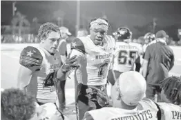  ?? MICHAEL LAUGHLIN/SUN SENTINEL ?? American Heritage running back Mark Fletcher speaks to his teammates during their game against Cardinal Gibbons on Friday.