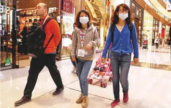  ?? Clint Egbert/Gulf News ?? Chinese tourists in Dubai Mall wear masks as a precaution for coronaviru­s. Reported data suggests 1.4 million Chinese tourists visited GCC in 2018.