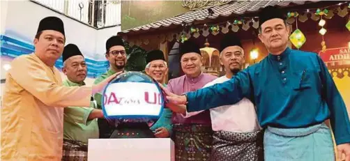  ??  ?? UDA acting chief executive officer Zahrin Zakaria (third from left) launching the UDA Cares programme at the Aidilfitri Open house on Wednesday.