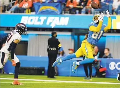  ?? ASHLEY LANDIS AP ?? Chargers receiver Mike Williams goes airborne to catch quarterbac­k Justin Herbert’s 35th touchdown pass, a team record.