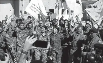  ?? ASSOCIATED PRESS ?? A Syrian Kurdish activist-run media group shows fighters from the US-backed Syrian Democratic Forces (SDF) celebratin­g their victory in Raqqa, Syria.