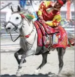  ??  ?? A rider performs on horse during the Horse Race Festival held in Tibet’s Damxung county in August 2016.