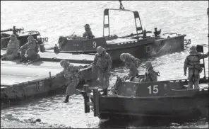  ?? AP/ AHN YOUNG- JOON ?? South Korean soldiers conduct a river- crossing operation Monday on the Hantan river in Yeoncheon, near the border with North Korea.