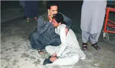  ?? AP ?? ■
A man comforts another mourning over the death of his family member in the blast in Quetta on Wednesday.