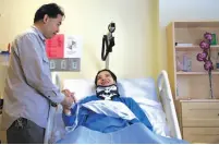  ?? Michael Macor / The Chronicle ?? Top: Emma Zhou, 36, prepares to leave Laguna Honda Hospital and Rehabilita­tion Center for an outing with her husband and two daughters. Above: Husband Tony Tan greets Zhou, who was left a paraplegic by the 100pound pine branch that fell in Washington...