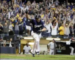  ?? MORRY GASH — THE ASSOCIATED PRESS ?? Milwaukee’s Mike Moustakas celebrates after his RBI single in the 10th inning of Game 1 gave the Brewers a 3-2 win over Colorado.