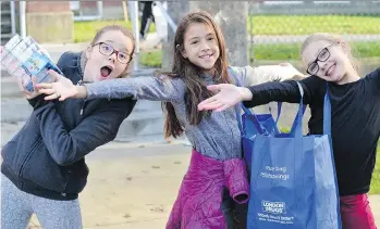  ??  ?? Students at Lord Strathcona Elementary help unload a London Drugs truck in their annual Adopt-A-School toy drive. Company employees are closely involved with the annual toy drive.