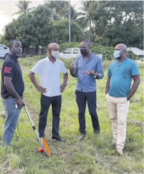  ?? ?? Member of Parliament for Westmorela­nd Western Morland Wilson (second right) makes a point to (from left) Andre Fowls, Sports Developmen­t Foundation (SDF) project manager; Terry Montague, SDF chief engineer; and councillor for the Friendship division Kevin Murray during a tour of the Prospect playfield in the constituen­cy last Friday.