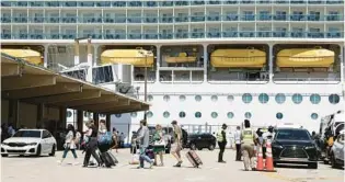  ?? CARLINE JEAN/SOUTH FLORIDA SUN SENTINEL ?? People wait to board the Royal Caribbean Vision of the Seas at Port Everglades in Fort Lauderdale on Friday. Cruise travel is picking up again, but COVID-19 is still an issue on ships.