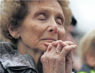  ?? ANGELA ROWLINGS PHOTOS / BOSTON HERALD ?? SOLEMN PRAYER: Elaine Marmer of Framingham prays during a vigil on Boston Common yesterday for the Tree of Life synagogue shooting victims.