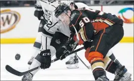  ?? Alex Gallardo Associated Press ?? THE DUCKS’ Antoine Vermette keeps an eye on the puck after a faceoff with Michael Amadio of the Kings during the first period of Friday night’s game.