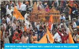  ?? — AFP ?? NEW DELHI: Indian Hindu hardliners hold a cutout of a temple as they participat­e in a rally yesterday.