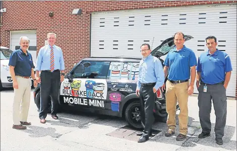  ?? SUBMITTED PHOTO ?? In this file photo, Montgomery County District Attorney Kevin R. Steele, second from left, is joined by Pennsylvan­ia American Water officials to unveil the addition to his Drug Take Back program. The “Pill Take Back Mobile MINI” visits community events.