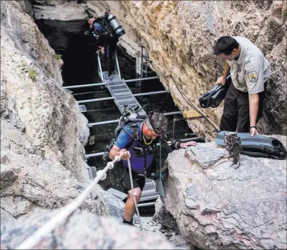  ?? Patrick Connolly ?? Las Vegas Review-journal @Pconnpie Kevin Wilson, an aquatic ecologist for the National Park Service, descends toward the water of Devils Hole for a biannual count of the Devils Hole pupfish.