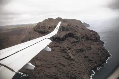  ?? Gianluigi Guercia / AFP / Getty Images ?? A picture taken from the first commercial flight shows the cliffs of the volcanic island of St. Helena in the southern Atlantic.