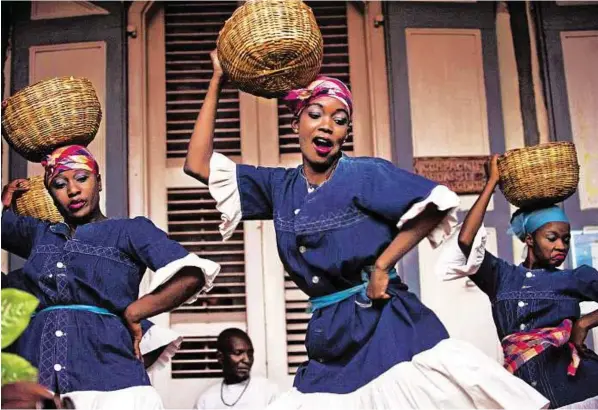  ?? AFP ?? Dancers perform in Haiti as part of a project to preserve the country’s gingerbrea­d houses. Internatio­nal money transfers form nearly a quarter of the Haitian GDP