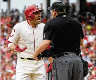  ?? ANDY LYONS / GETTY IMAGES ?? Reds first baseman Joey Votto has words with home plate umpire Dan Bellino after striking out in the first inning Sunday against Hyun-Jin Ryu and the Los Angeles Dodgers at Great American Ball Park in Cincinnati. Votto was 0-for-3 with a walk in an 8-3 Reds loss.