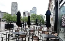  ??  ?? READY FOR CUSTOMERS: Outdoor tables wait for customers on Boylston Street which will be allowed starting today.