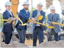  ?? AMY BETH BENNETT/SOUTH FLORIDA SUN SENTINEL ?? Boca Raton Mayor Scott Singer, from left; Brightline President Patrick Goddard; U.S. Rep. Ted Deutch, D-Boca Raton; and Discover The Palm Beaches CEO Jorge Pesquera toss shovels full of dirt during a ceremonial groundbrea­king held Monday to announce a new Brightline station in Boca Raton.