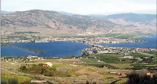  ?? Penticton Herald archives ?? The view looking west from Anarchist Mountain onto Osoyoos with the Cathedral Mountains in the background. Osoyoos was voted the most beautiful small town in Canada in 1995.
