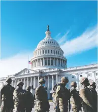  ?? ROD LAMKEY/POOL/AFP VIA GETTY IMAGES ?? Members of the National Guard arrive at the U.S. Capitol
ahead of Wednesday's inaugurati­on of Joe Biden.