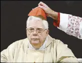  ?? AP ?? Cardinal Bernard Law has his skull cap adjusted during a mass in Rome in a photo taken in 2004.