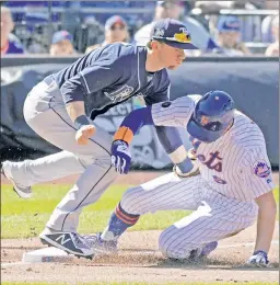  ?? Bill Kostroun ?? BRAN-DONE: Brandon Nimmo is caught stealing at third as the Rays’ Matt Duffy puts on the tag in the first inning of the Mets’ loss on Saturday. A video review overturned an initial safe call on the play.