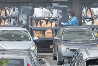  ?? Chip Somodevill­a, Getty Images ?? An Amazon Flex driver loads their personal vehicle with packages outside the 1.2 million-squarefoot BWI2 Amazon Fulfillmen­t Center in the Chesapeake Commerce Center on April 14 in Baltimore, Md.