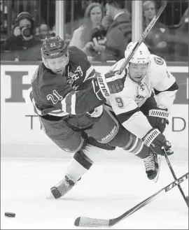  ?? KathyWille­ns
Associated Press ?? THE RANGERS’ DEREK STEPAN (21) gets tangled up with Tampa Bay’s Tyler Johnson during the second period of Game 1 of the Eastern Conference finals.