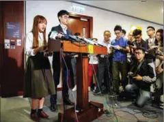  ?? ANTHONY WALLACE/AFP ?? Yau Wai-ching (left), and Baggio Leung, (second from left), were yesterday disqualifi­ed from parliament by a court in Hong Kong.