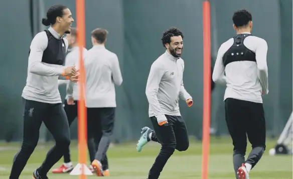  ??  ?? Liverpool players Mohamed Salah and Virgil van Dijk take part in training earlier in the season, something they will want to do quickly to get title push back on track.