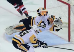  ?? ED MULHOLLAND/USA TODAY SPORTS ?? Penguins goalie Casey DeSmith (1) makes a save against the Devils during the second period on Friday.