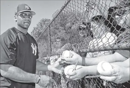  ?? N.Y. Post: Charles Wenzelberg ?? SIGN HIM UP: Seahawks quarterbac­k Russell Wilson, who struck out in the only at-bat of his stint in Yankees camp, signs autographs Saturday on his final day before returning to his offseason NFL training.