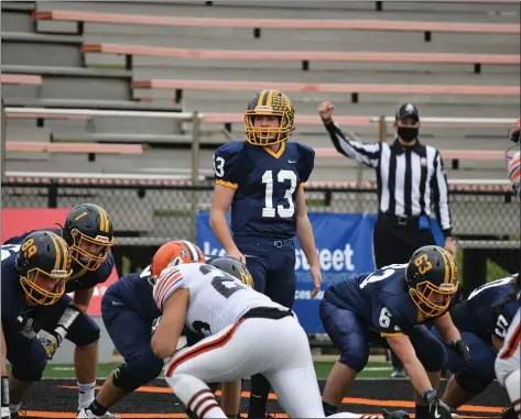  ?? PAUL DICICCO - FOR THE NEWS-HERALD ?? Liam Powers of Kirtland looks over the Ironton defense during the Hornets’ state championsh­ip win over Ironton Nov. 21.