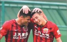  ?? XINHUA ?? Shanghai SIPG’s Chinese internatio­nal striker Wu Lei (right) celebrates with teammate and Brazilian star Hulk after scoring one of his four goals against Guangzhou R&F in their CSL match on Sunday.