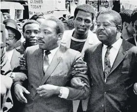  ?? SAM MELHORN / THE COMMERCIAL APPEAL /AP FILES ?? Dr. Martin Luther King Jr. and Rev. Ralph Abernathy, right, lead a march on behalf of striking Memphis sanitation workers in 1968.