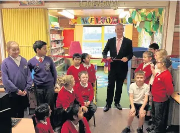  ??  ?? Graham Jones MP opening the new library at Sacred Heart RC Primary School in Church