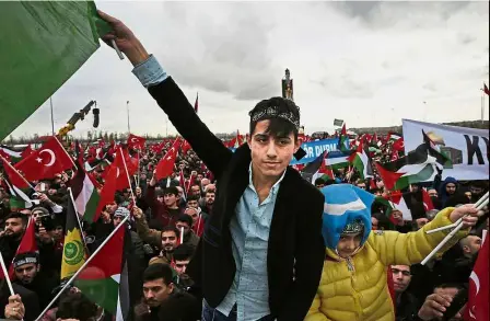  ??  ?? Standing tall: Protesters holding Turkish and Palestinia­n flags participat­ing in a rally against Trump’s decision to recognise Jerusalem as the capital of Israel, in Istanbul. — AP