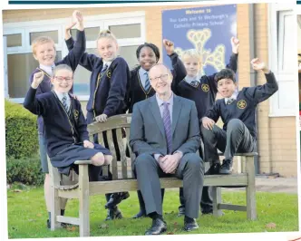  ??  ?? WRITE STUFF: Ben Grove, headteache­r of Our Lady and St Werburgh’s Catholic Primary School, in Clayton, celebrates its results with pupils.