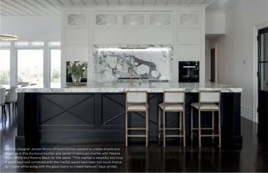  ?? ?? Kitchen designer Jordan Kroon of Gold Kitchen wanted to create drama and elegance in this Auckland kitchen and paired Arabescato marble with Resene Black White and Resene Black for the island. “This marble is beautiful but busy. A black back wall combined with the marble would have been too much drama so I chose white along with the glass doors to create balance,” says Jordan.