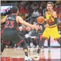  ?? Brett Davis ?? Atlanta Hawks guard Trae Young (11) is defended by Toronto Raptors guard Fred VanVleet (23) in the second half at State Farm Arena.