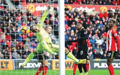  ??  ?? Liverpool’s Daniel Sturridge, centre, scores his side’s first goal in the 2-2 draw against Sunderland