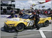  ?? SETH WENIG — THE ASSOCIATED PRESS ?? A car is pushed onto the track Aug. 21.