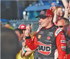  ?? AP PHOTO/CHARLIE NEIBERGALL ?? Christophe­r Bell celebrates with fans in victory lane after winning the NASCAR Xfinity Series race on June 16 at Iowa Speedway. Bell got his fifth win of 2019 on Saturday at New Hampshire Motor Speedway.