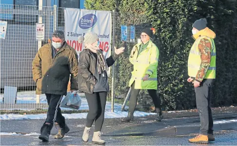  ??  ?? COVID UPSURGE: Workers outside the 2 Sisters poultry plant in Coupar Angus. Picture by Gareth Jennings.