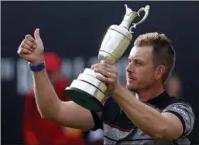  ?? FILE — THE ASSOCIATED PRESS ?? This July 17, 2016 photo of Henrik Stenson of Sweden holds up the trophy tom the crowd after winning the British Open Golf Championsh­ips at the Royal Troon Golf Club in Troon, Scotland. Swedish golfer Henrik Stenson golfer is playing the Scottish Open...