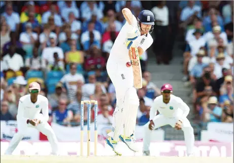  ??  ?? England’s cricket team captain Alastair Cook plays a shot during the first day of the final match of a three-match Test series between England and West Indies at
the Kensington Oval Stadium in Bridgetown on May 1. (AFP)