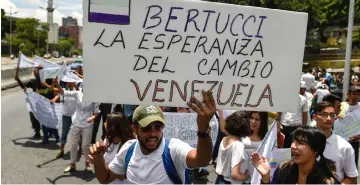  ??  ?? Supporters of Bertucci cheers during an electoral meeting in Caracas. — AFP photo