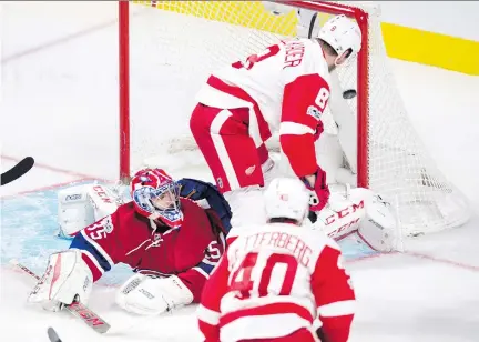  ?? PAUL CHIASSON/THE CANADIAN PRESS ?? Red Wings forward Justin Abdelkader scores a power-play marker for Detroit early in the first period Tuesday night at the Bell Centre. Al Montoya made a rare home start and stopped 34 of 36 shots.